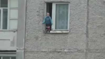 Russian kid checks out the view from his window