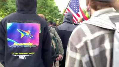 Mob of CHAZ residents call black man a "race traitor" for carrying the American flag