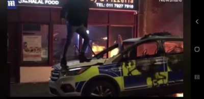 Posing on a burnt out police car for the insta