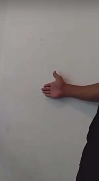 Punching Samuel's hand.