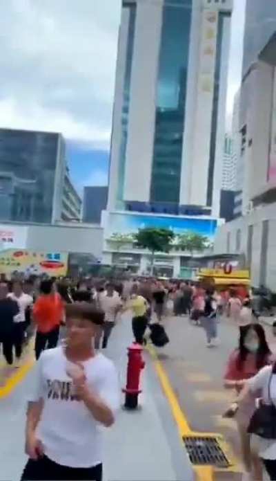 People run for their lives as building in Shenzen, China, begins to shake for no reason and tilted on its foundation