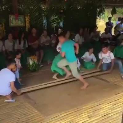 Filipino dancers performing a traditional dance called "Tinikling"