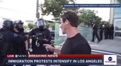 ABC News reporter Matt Gutman stays calm as an LAPD officer shoves him and yells in his face.