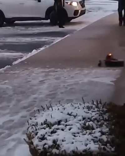 Using a toy plow truck to clear snow