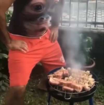 Man needs some help with the grill and his gut is there for him