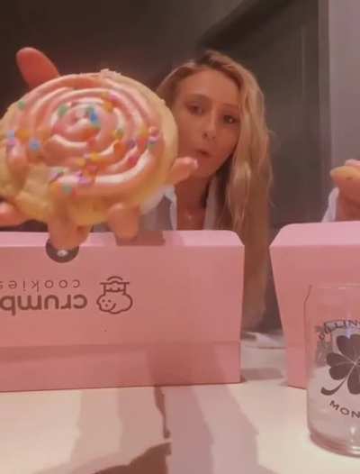 Showing the camera her expensive, gourmet cookie