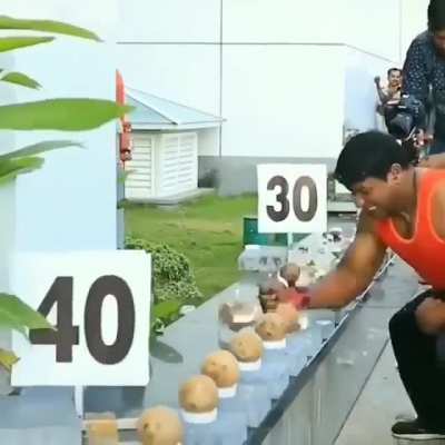 Breaking 150 coconuts with bare hands