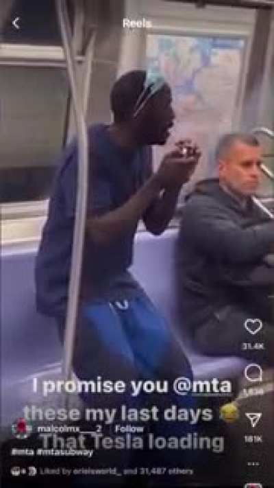 Man takes a well earned smoke break on the NYC subway