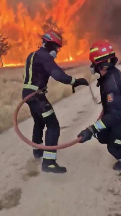 Firefighters in Madrid trying to extinguish a forest fire that is less than 30km/20mi away from the capital of Spain