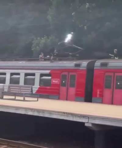kids casually playing witg a high voltage train thingie