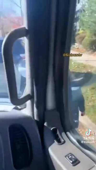 Older lady blocks work truck, attempts to take picture with her flip phone.