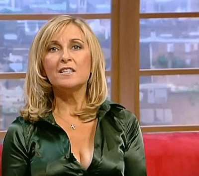Fiona Phillips with a nice deep cleavage in a tight Satin Blouse