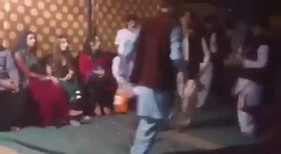 At a wedding in Pakistan. He is objecting to her public performance.