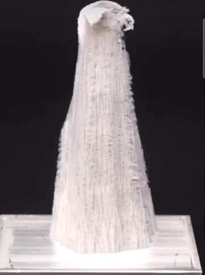 Mercury disrupts aluminum's oxide layer, enabling it to react with air. This forms white, fibrous aluminum oxide, visibly growing as delicate structures.