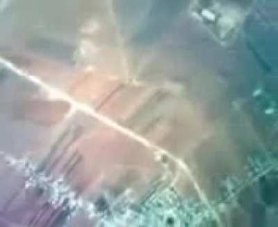 Rare footage from inside a Syrian regime helicopter during a barrel bomb attack, soldier lights the bomb with his cigarette before pushing it out. October, 2012. Syria.