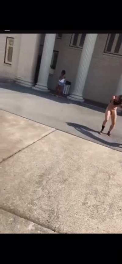 That crackhead is naked fighting another crackhead in front of the church