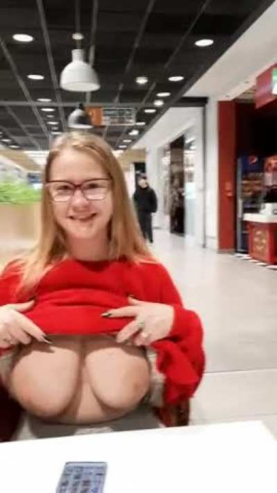 In a shopping mall - normally, as in such places, stores, restaurants, cinema, people are hanging around - not sure what for. I know why I'm there. I show my huge boobs. Heh