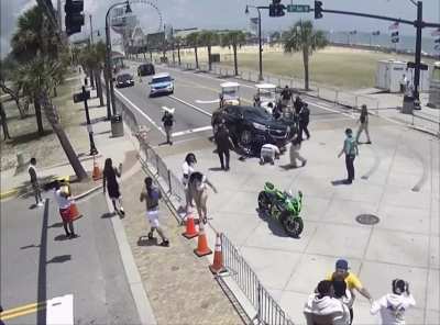 Bystanders and police lift car off of motorcycle rider. Myrtle Beach, SC