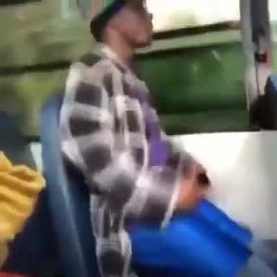 Blackkk man sitting in Public transport