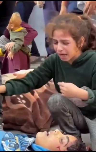 Palestinian Girl Comforts Her Grieving Brother Over Their Sibling's Passing: "He is gone to join dad, pray for him"