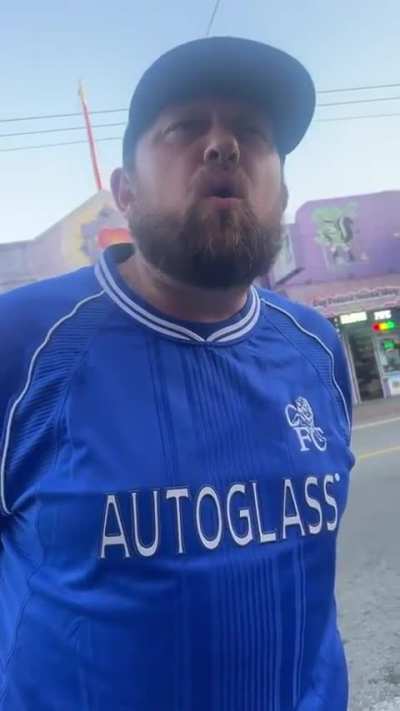 Drunk man has his leg touched by protestors sign after 