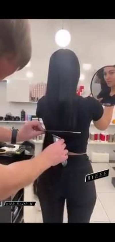 Cutting her hair.