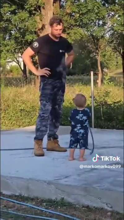A kid and his garden hose