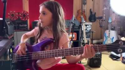 Little girl is playing some funky music