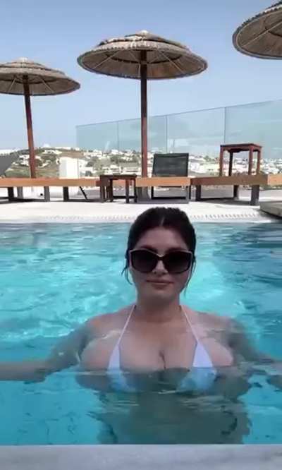Her bikini is overflowing and so is the pool