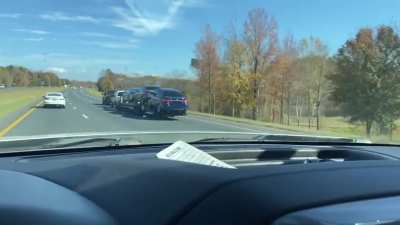 Truck pulling truck pulling trailer with cars with ratchet strap at 75mph.