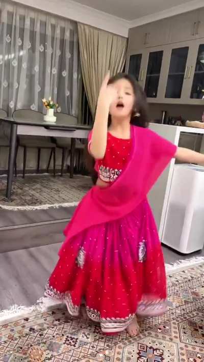 Uyghur girl dancing to Bollywood music, dressed in Indian clothes