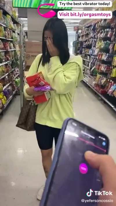 Controlling her vibrator at the shop