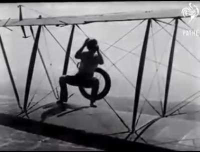 A woman replaces the wheel of a plane mid-flight.