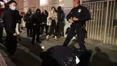 LAPD gets surrounded by protesters while trying to arrest a man who then gets away.
