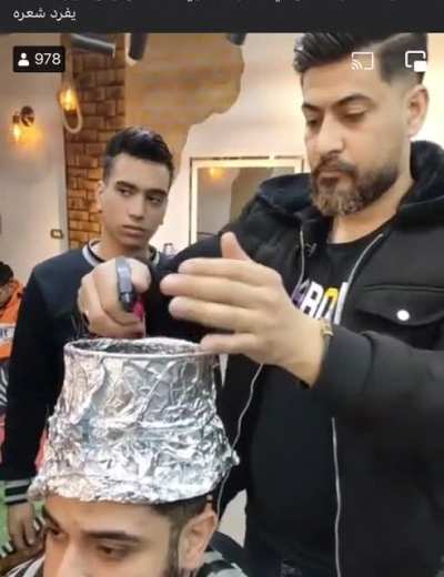 This Egyptian barber/chef giving a haircut and cooking kebabs on his client&rsquo;s head