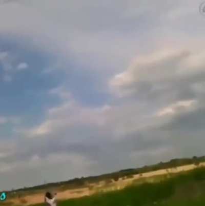 Kid throwing a copper wire-wrapped rock at a power line