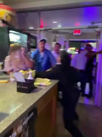 Female police officer goes ballistic in what looks to be a restaurant or a bar