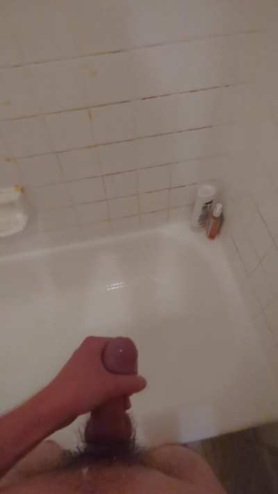 Spraying piss all over the shower while stroking