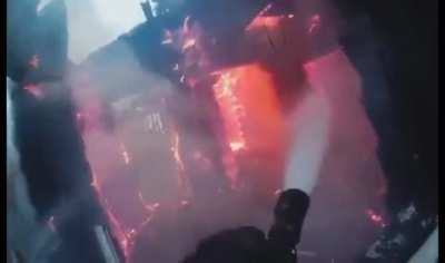 Gopro view of a firefighter putting out a house fire. Effective work. The bright red fire rapidly dying (with sound)