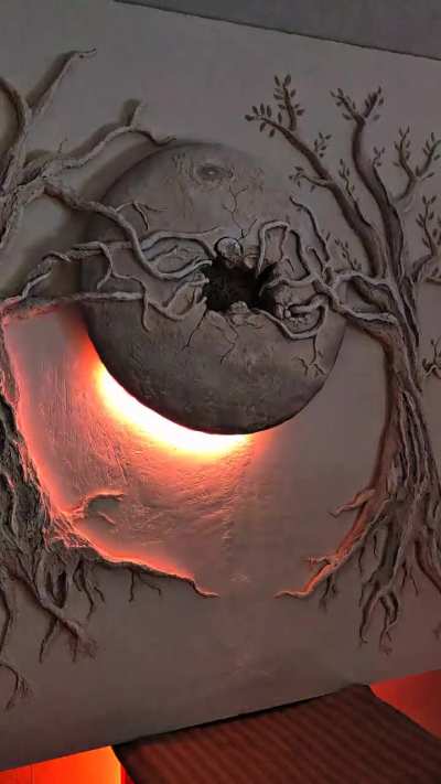 Wall relief sculpture with integrated RGB LED lighting — app-controlled core and perimeter animation