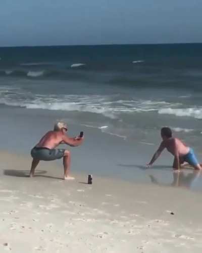Dads imitating their daughters on the beach