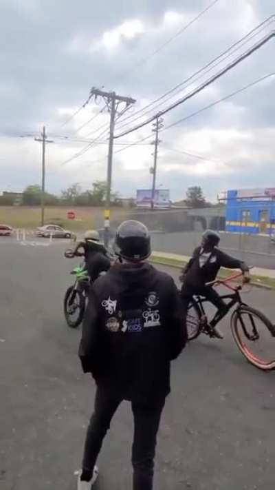 Kid does a wheelie on a dirt bike