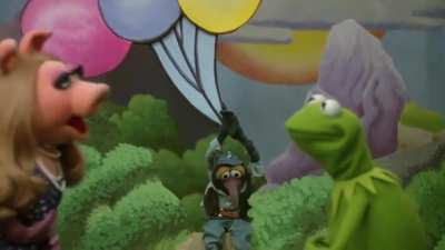 Kermit the Frog (Jim Henson) sings "The Rainbow Connection", as the opening and closing number of The Muppet Movie from 1979.