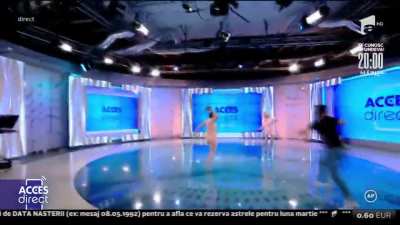 Naked woman throws a stone at tv presenter in Romania - She knows "Brick Throwing" but not "Frog Being"