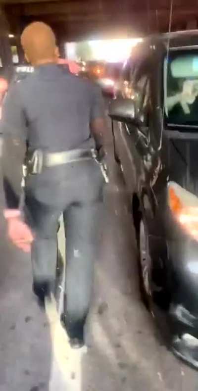 Officer gets confronted by another officer for pushing a girl who was on her knees with her hands up.