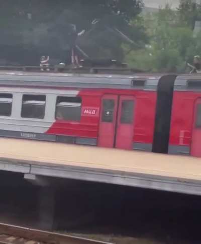 Kids casually playing with a train high voltage pantograph