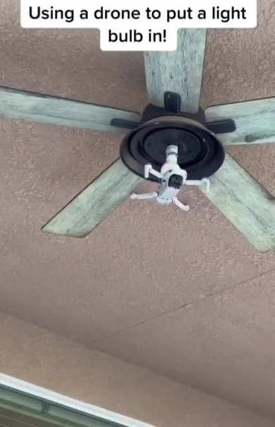 Using a drone to screw a lightbulb.