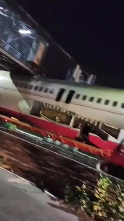WCGW driving a truck loaded with a fuselage under a bridge
