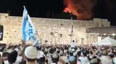 People celebrating while a Palestinian mosque is on fire...