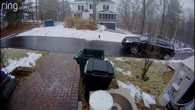 Woman's car glides down icy street
